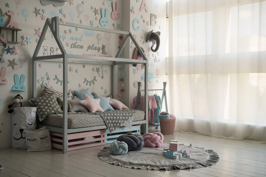 Interior of a children's room with a cradle and toys. Pastel colors, modern design.