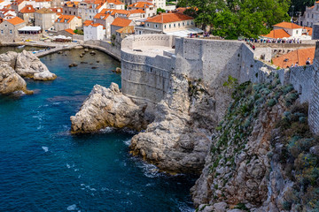View of Dubrovnik old city stone walls on rocks and blue Adriatic Sea, Dalmatia, Croatia, blue summer day, the most popular touristic travel destination  