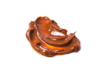 Melted tasty caramel splashes isolated on white background.