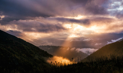 Fairy landscape with dramatic sky and sunbeam in mountains - Powered by Adobe