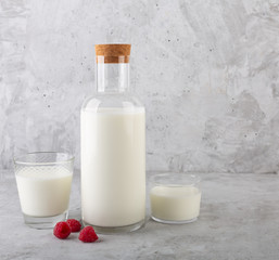 Kefir drink with raspberry on the gray background