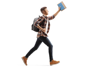 Male student running and holding a book