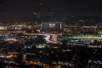 Obraz premium Night cityscape view of downtown Burbank and the Interstate 5 freeway in Los Angeles County, California. 