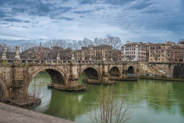 Sant'angelo bridge over the Tiber river in Rome on a cloudy winter day