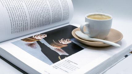 cup of coffee and pen on table
