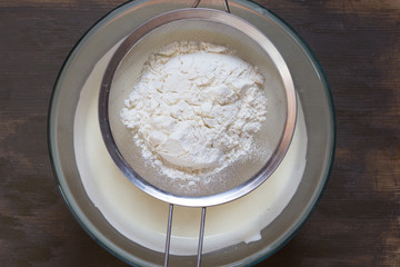 Flour in sifter on the bowl before the sifting