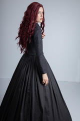 Long-haired Victorian woman in black ensemble