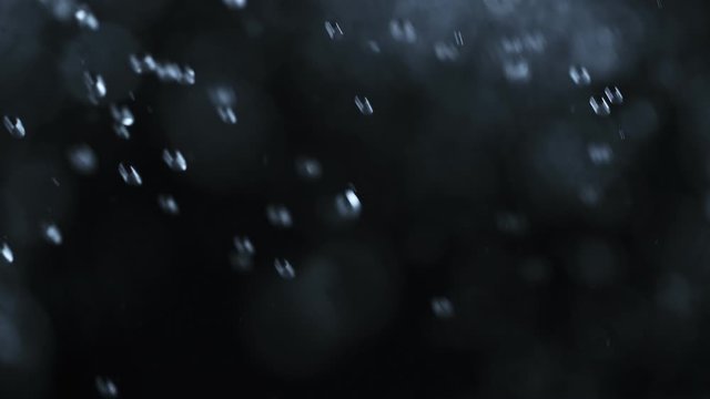 Super Slow Motion Abstract Shot of Water Shower at 1000fps Isolated on Black Background. Shooted with High Speed Cinema Camera at 4K Resolution