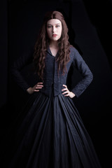 Long-haired Victorian woman in black ensemble