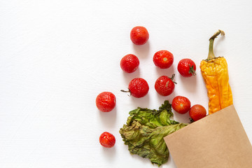 Spoiled vegetables in a package on a white background
