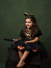 Cute child girl in witch costume for Halloween, close-up