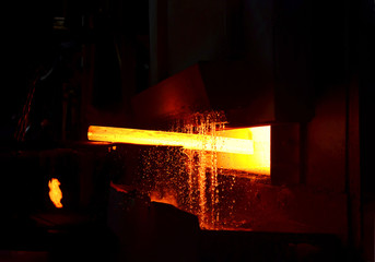 Steel quenching at high temperature in industrial furnace at the workshop of a forge plant. Process...