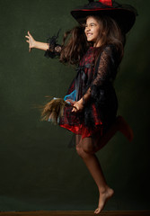 Cute child girl in witch costume for Halloween, close-up