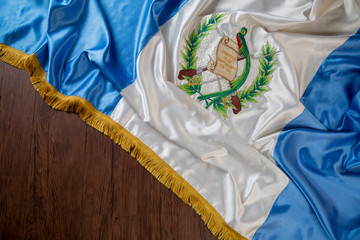 Flag of Guatemala on wooden background- with space for text