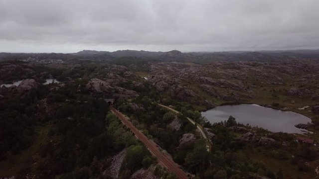 Aerial flying over S&oslash;rlandet Line rails and the rocky landscape in Egersund, Norway