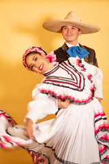 Charro and Adelita dancing young couple portrait in love folk culture 