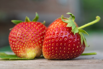 ripe and red strawberries lie on a wooden background, healthy food, organic food.