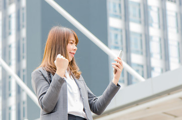 Fototapeta premium Business women looking phone She is smiling and happy