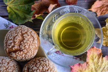 Delicious lush buns and a cup of green tea are cooked for breakfast, top view