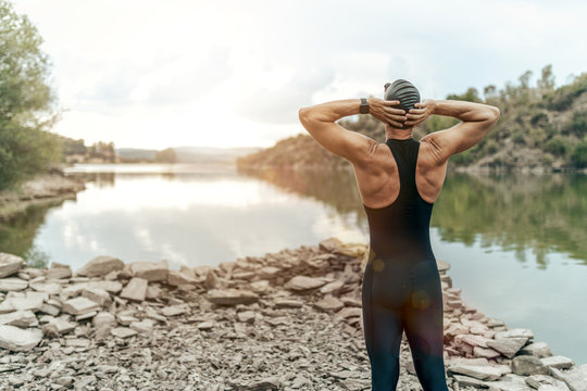 swimmer in swimsuit glasses and cap in open water
