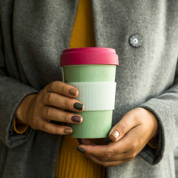 Modern coffee cup in the concept of zero waste in a woman's hands
