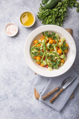 Salad with cucumber, tomato cherry,  onion and paprika. Top view on grey concrete background.