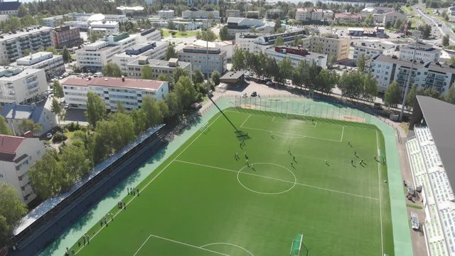 Soccer/football game on a sunny summer day, drone aerial on a summer day in Rovaniemi Finland