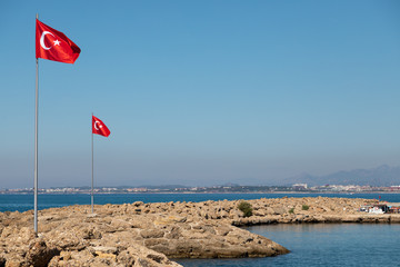 in the port of Side the Turkish flag blows at a mast