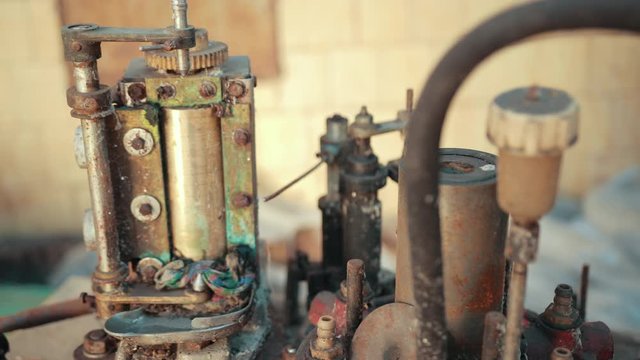 many old scrap, faulty, rusted mechanism, old machine from the factory, gears, which are a lot of rubber belts, slow motion, close up