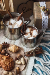 Metal mugs with cacao and marshmallows