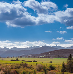 Fototapeta premium Panoramic View Of Field And Mountains Against Sky