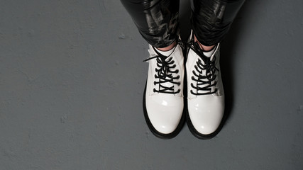 White female fashion white lace-up shoes on gray background. Women's shoes. Stylish white shoes....