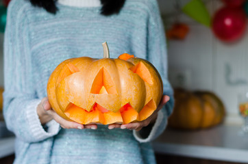 girl holding a pumpkin for halloween. close-up