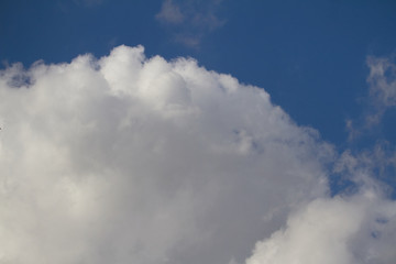 Fototapeta na wymiar Big white cloud in the blue sky, copyspace