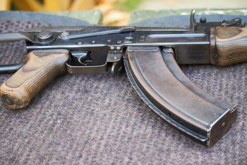 Close-up of a Kalashnikov assault rifle at a shooting range stand in an amusement park, selective...