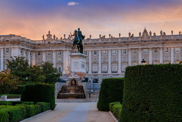 Fototapeta premium Sunset by the Royal Palace or Palacio Real with king Philip IV statue in Plaza de Oriente in Madrid Spain built in 1639
