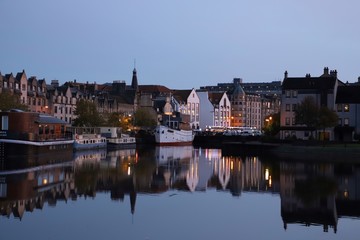 Leith waterfront buildings & boats casting shadows on water at sunset