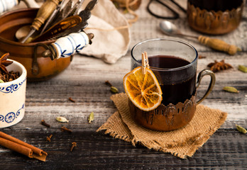 homemade mulled red wine with cinnamon, anise, cardamon and orange in glass jars