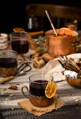 homemade mulled red wine with cinnamon, anise, cardamon and orange in glass jars