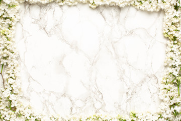 White lilac flowers on marble background, simple composition with spring flower