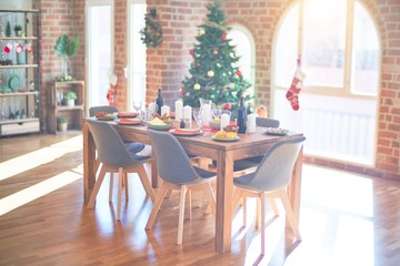 Nice home with tree, ornamets and table with food prepared to celebrate Christmas.