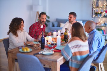 Beautiful family smiling happy and confident. Eating roasted turkey celebrating Christmas at home
