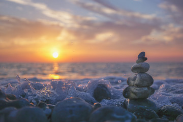 hareubang pebble reflection at sunset over the sea - zen and relaxation	 - obrazy, fototapety, plakaty