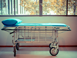 Stretcher Troller or Patient bed in the hospital near the windowpane prepared for patient services.