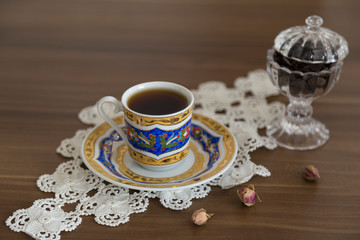 a cup of coffee on the wooden background.