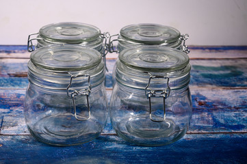Glass jar with lid and metal lock for storing spices.