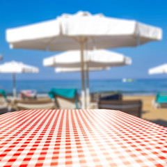 Wooden table board with and beach landscape. Empty space for your decoration and advertising product.