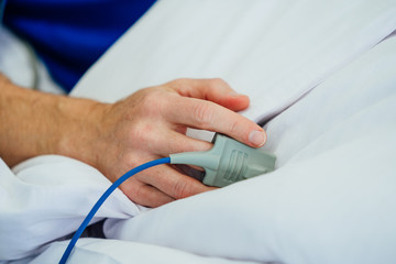 Focus on the hand of a patient in hospital ward. closeup of a hand in clinic bad.
