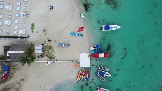 Dominican republic Boca Chica beach near capital Santo Domingo. Crystal clear sea with beautiful beach shot by drone. Aerial video of coastline environment. 