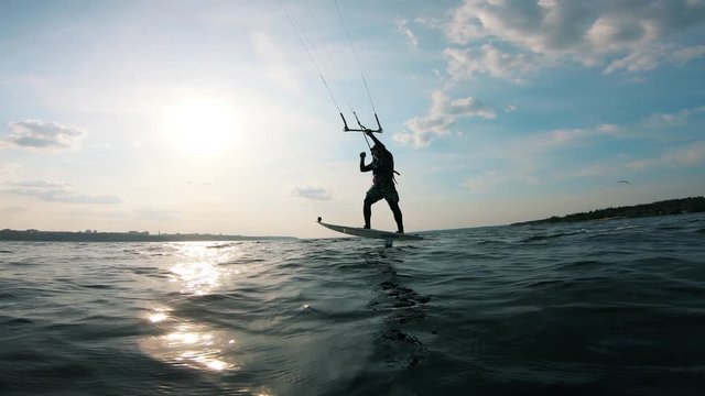 A man kite surfing on river. Kite surfer kiteboarding.